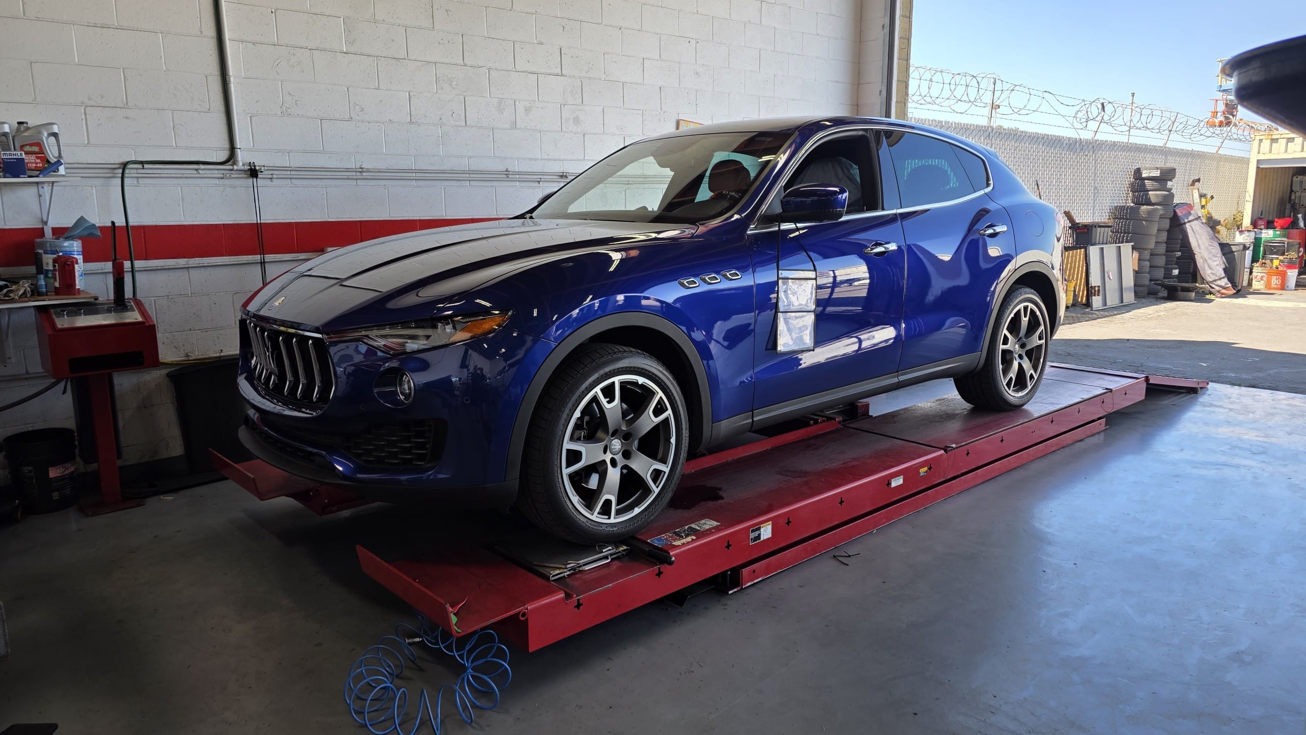 20250924_130131 Blue Maserati SUV on a lift at Select German Car Service in San Diego